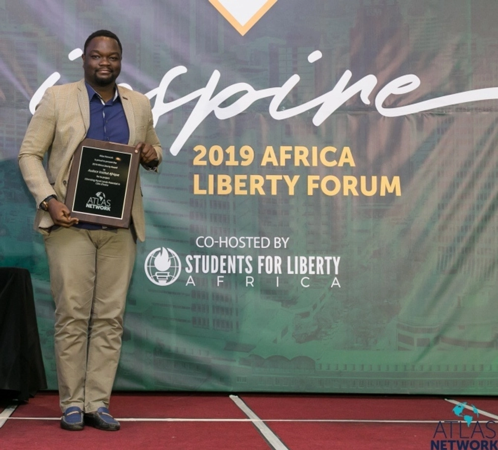 A man hold his plaque at the Africa Liberty Forum.