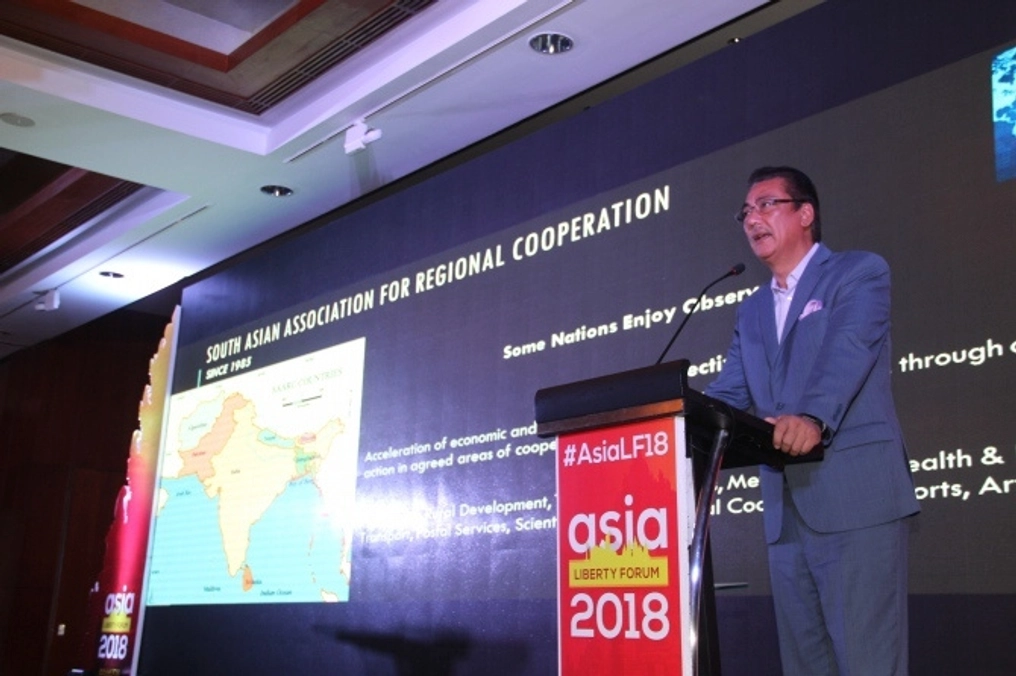 A man on stage speaking at the 2018 Asia Liberty Forum.