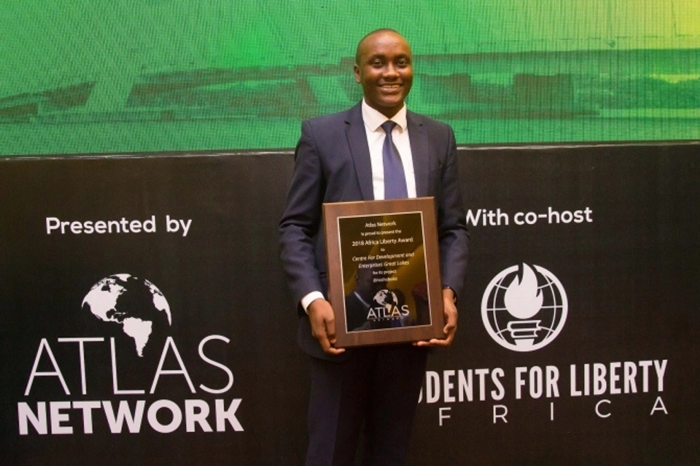A man proudly holds his plaque at the Students for Liberty Africa event.