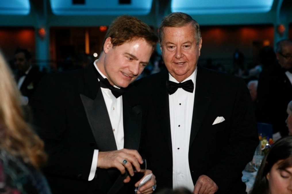 Two men, Palmer and Smith, wearing tuxedo's at an awards banquet.