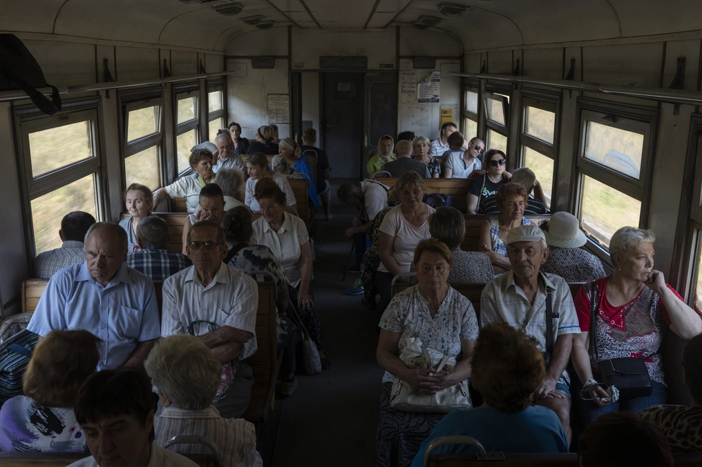 It is not uncommon to have small countryside homes for those who live in apartments in the city. Viktor and Lubov (front right) take a train from Ternopil to their dacha (AtlasNetwork.org Photo/Bernat Parera).