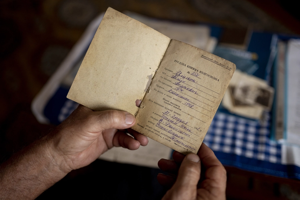 Viktor reads through his father’s notebook cataloging his daily work on the collective farm (AtlasNetwork.org Photo/Bernat Parera).