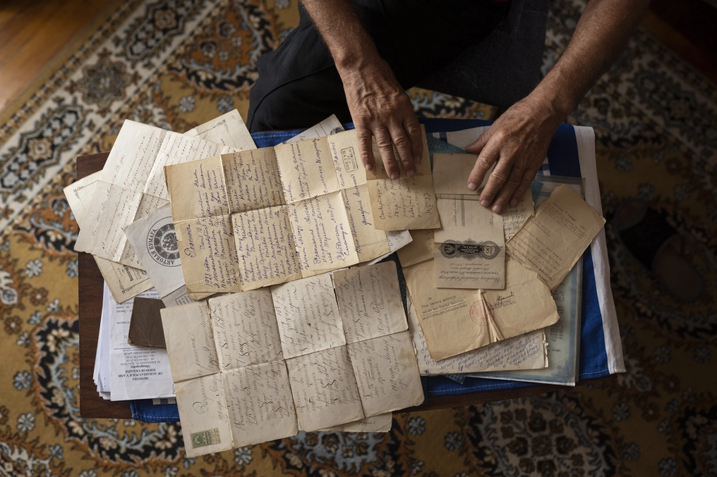 Viktor looks through personal family papers dating back to the 19th century (AtlasNetwork.org Photo/Bernat Parera).