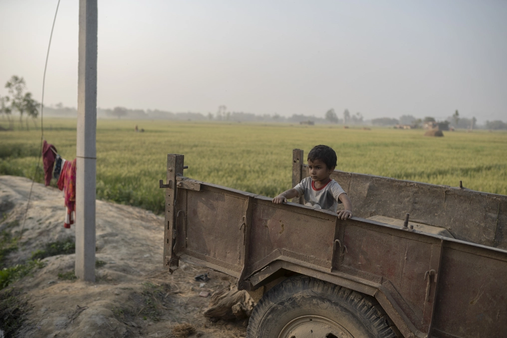 Lorik’s young son plays while his father prepares for work. (AtlasNetwork.org Photo / Bernat Parera)