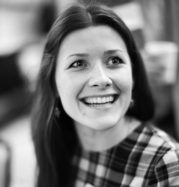 Yuliya Tychkivska smiles for a black and white photo.