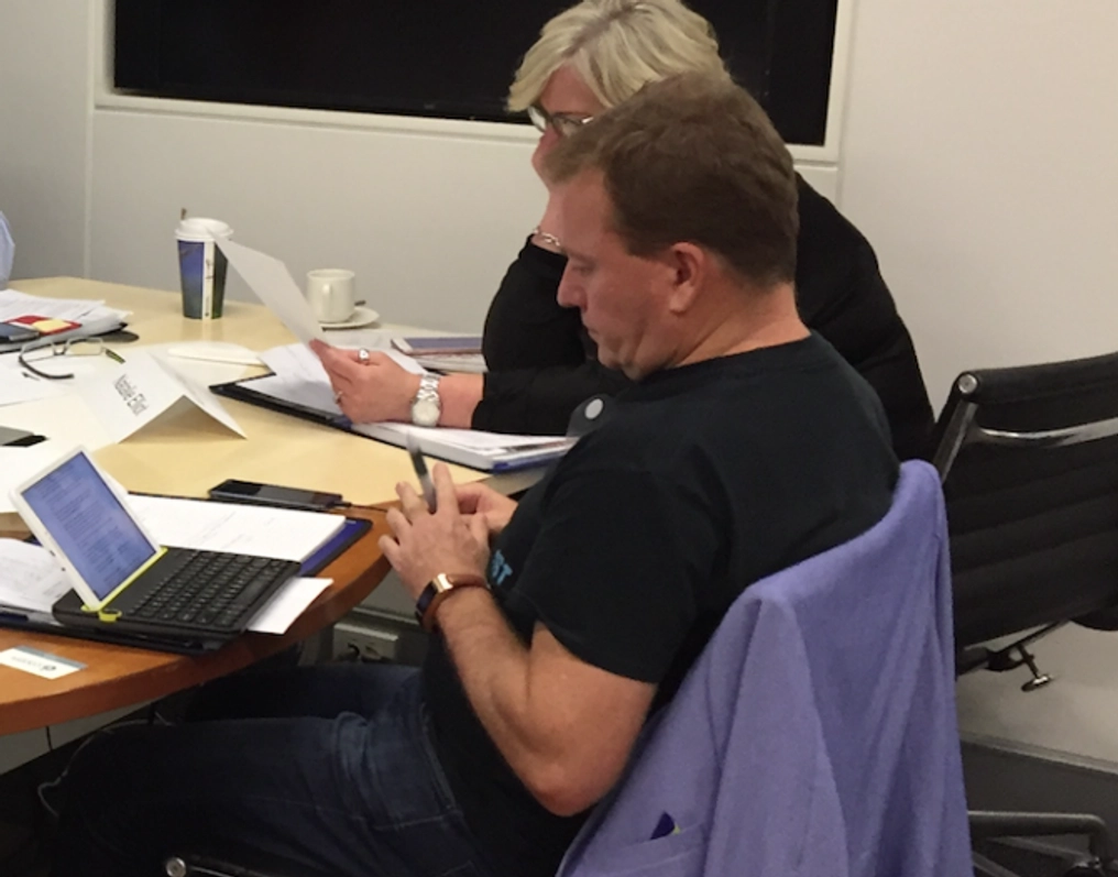 Andrew cooper sits while working at a laptop computer.