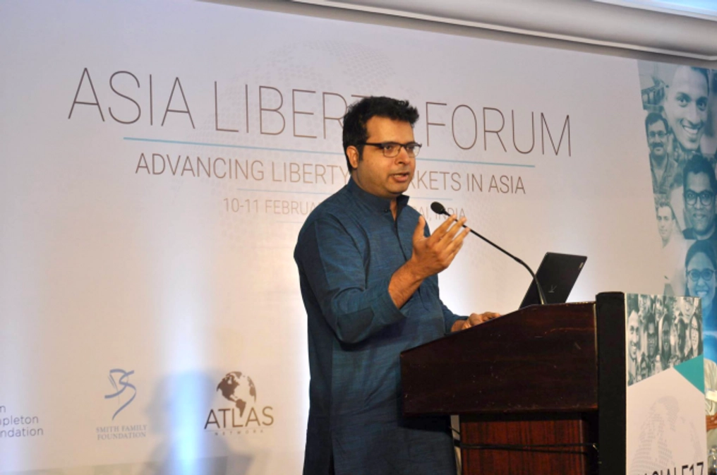 A man speaks on stage at the Asia Liberty Forum.