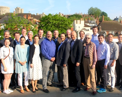 CEO Summit participants and Atlas Network staff gather for a group photo on the footbridge connecting Eaton and Windsor.