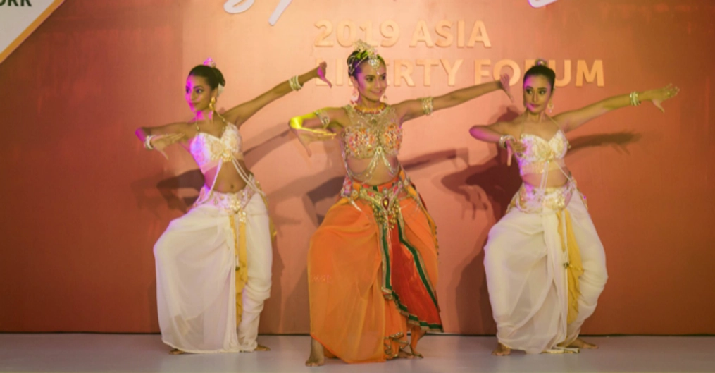 Three female dancers onstage.