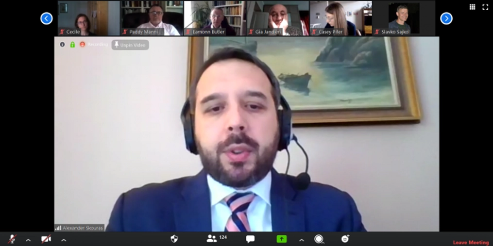 A man wearing a headset speaking on a video conference from Lithuania.