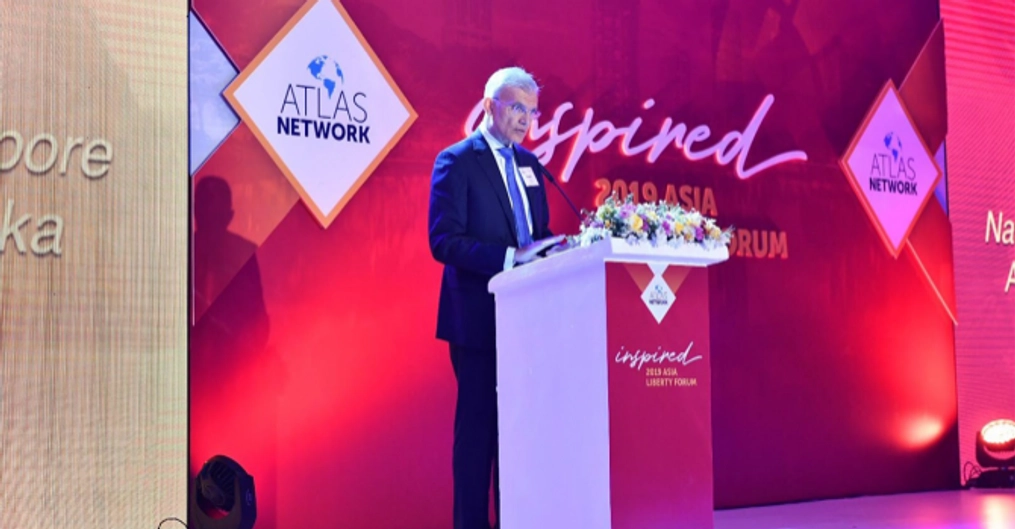 A man on stage at the Atlas Network 2019 Asia Liberty Forum.